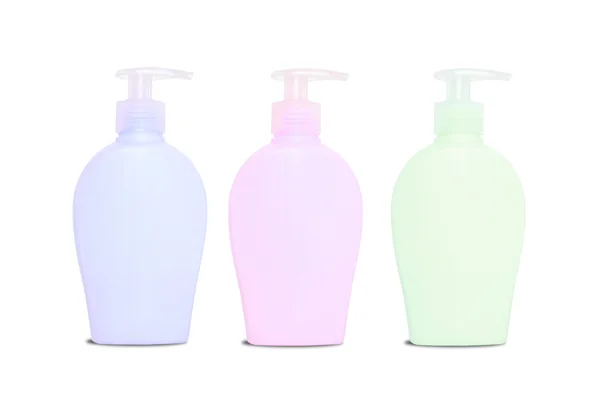 Trzy puste kolorowe mydło dispencers — Zdjęcie stockowe