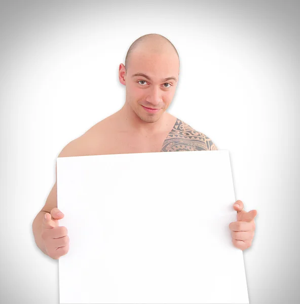 Jovem muscular homem segurando branco bordo — Fotografia de Stock