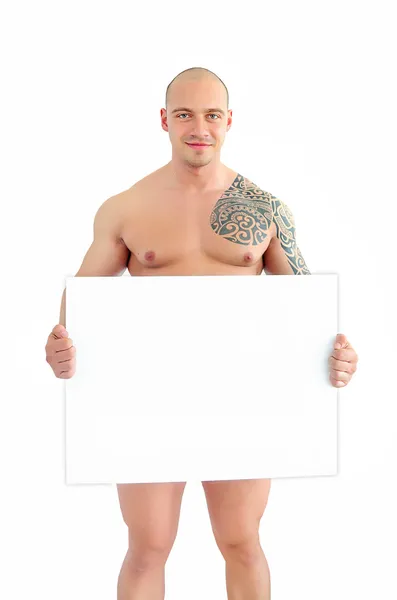 Jovem muscular homem segurando branco bordo — Fotografia de Stock