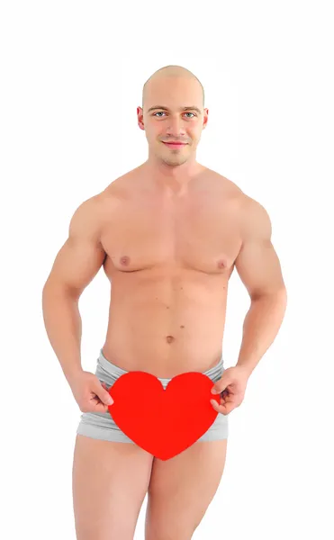 Jovem muscular homem segurando coração — Fotografia de Stock
