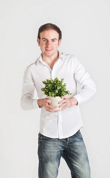 Young man with plant — Stock Photo, Image