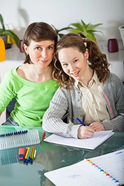 Девочка делает домашнее задание со своей мамой — стоковое фото