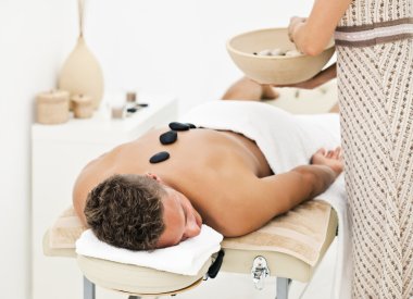 Young man enjoying spa treatment clipart