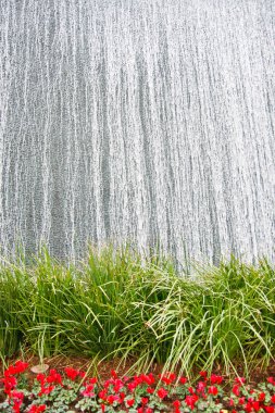 Fountain of Silver Water Over a Garden clipart