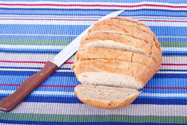 stock image Fresh Whole Grain Bread Sliced on Placemat with Knife