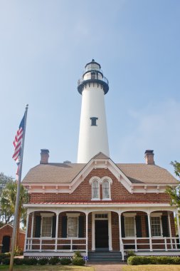 Amerikan tuğla ev arkasında beyaz deniz feneri