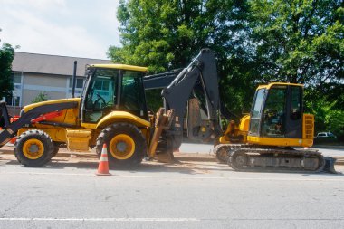 Two Pieces of Road Equipment on a Street clipart