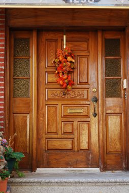 A grand main entrance of a house with halloween decoration