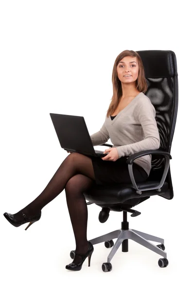 Jovem senhora de negócios em uma cadeira com um laptop — Fotografia de Stock