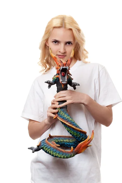Beautiful girl with a wooden dragon — Stock Photo, Image