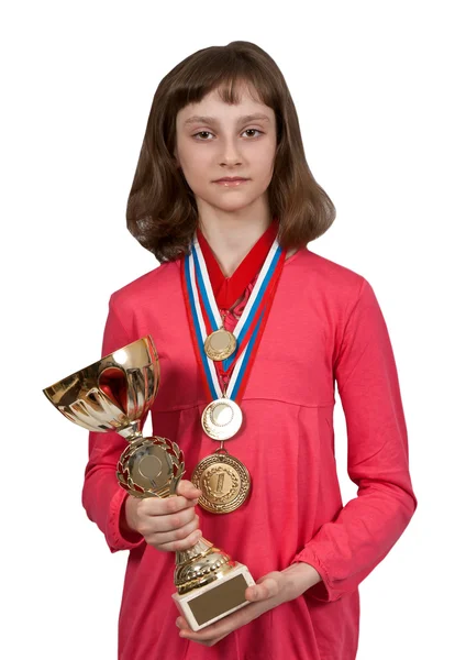 Menina com medalhas de ouro e uma xícara — Fotografia de Stock