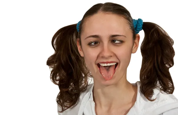 Menina com tranças mostra a língua — Fotografia de Stock