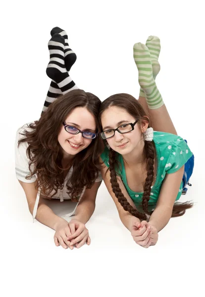 Two sisters lying on a white floor — Stock Photo, Image