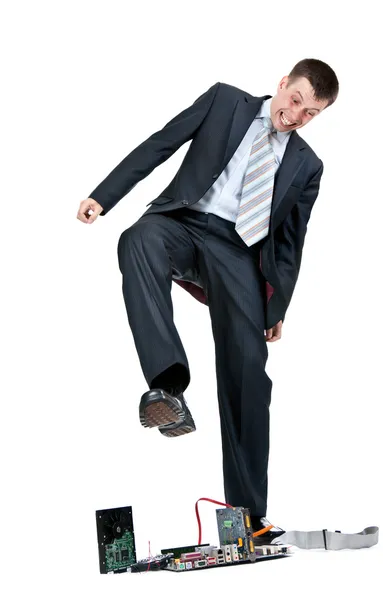 Businessman trampling foot motherboard — Stock Photo, Image