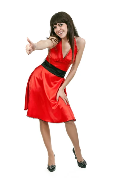 Brunette girl in red dress shows OK — Stock Photo, Image