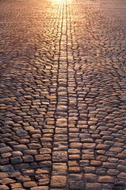 Stone pavement in evening sunlight clipart