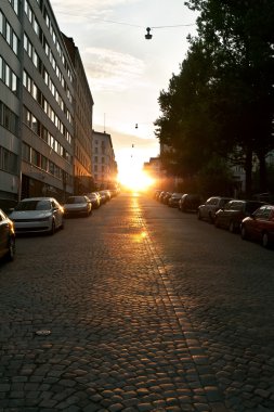 European narrow street with parked cars clipart