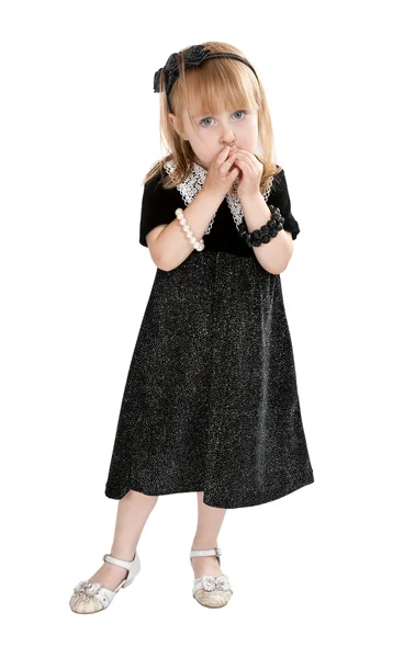 Klein meisje in een jurk op een witte achtergrond — Stockfoto