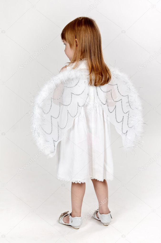 Little girl with angel wings in the studio