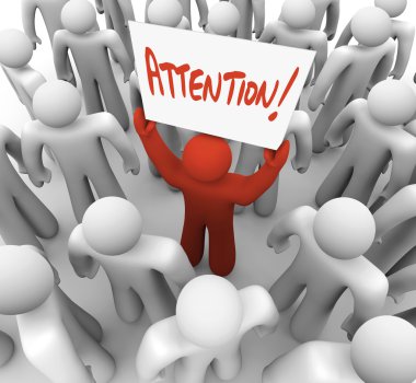 Person Holding Attention Sign in Crowd to be Recognized clipart