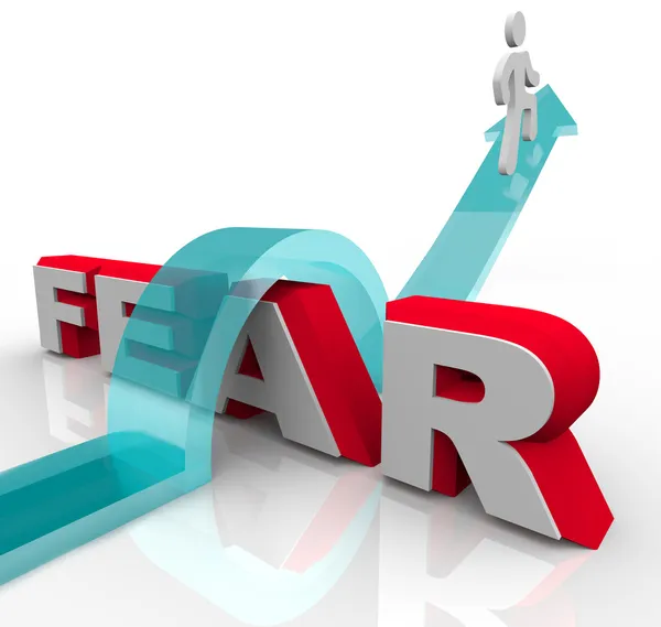 Conquering Your Fears - Jumping Over Word to Beat Fear — Stock Photo, Image