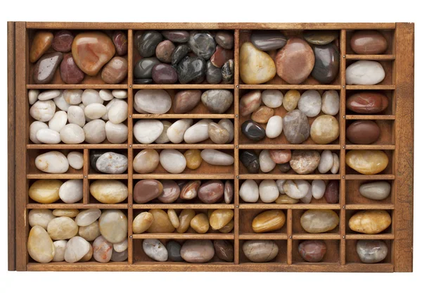 River pebbles in typesetter drawer — Stock Photo, Image