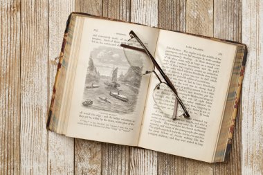 Antique book on a grunge table clipart