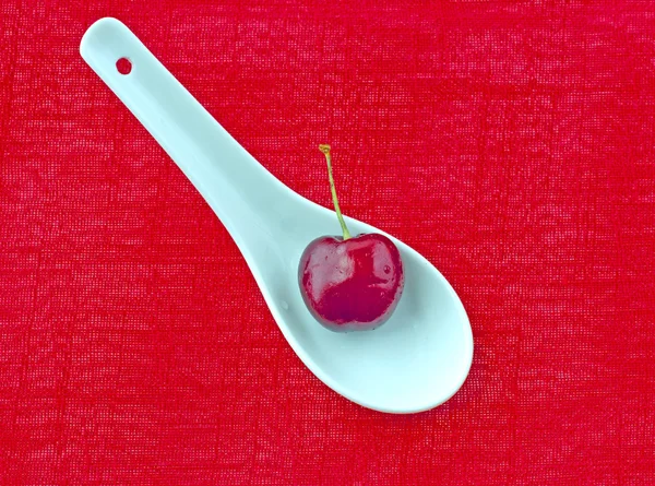Cherry over spoon — Stock Photo, Image