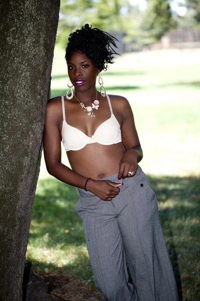 Attractive black woman outdoors slacks and bra — Stock Photo, Image