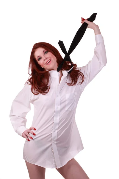 Smiling redhead woman white shirt holding tie up — Stock Photo, Image