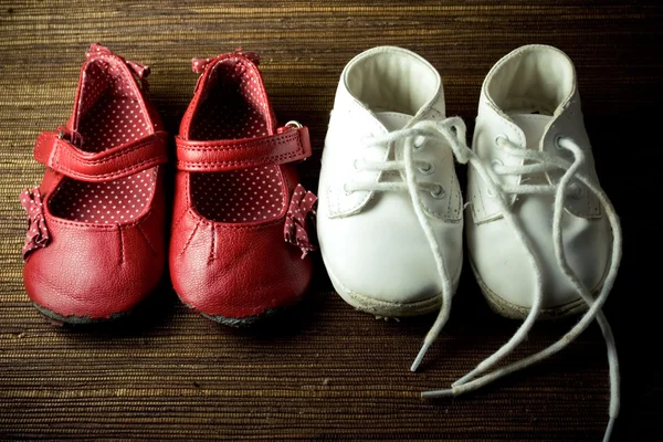 Stock image Two pairs of worn baby shoes