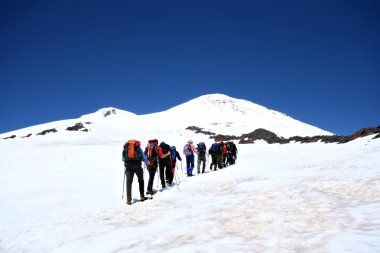 Alpinists at the Elbrus climbing in Caucasus. clipart