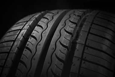 Car tire on black background clipart