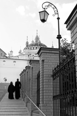 Lantern, two priests and church.Kiev-Pechersk Lavra monastery in Kiev. Ukra clipart