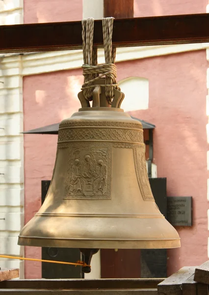 Bell against the background of the pink monastery's walls — Stock Photo, Image