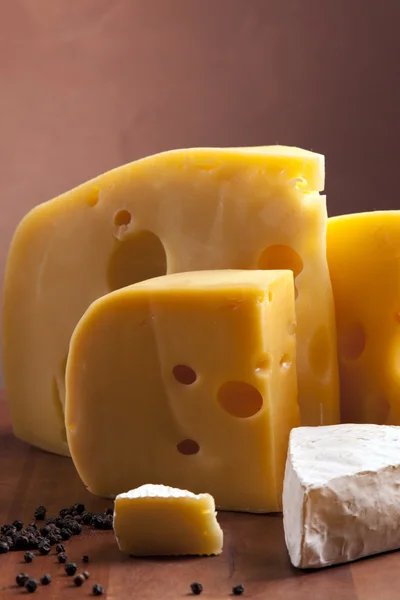 stock image Cheese, wine and other tasty stuff on wooden table