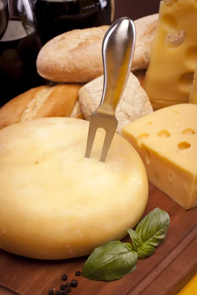 stock image Cheese, wine and other tasty stuff on wooden table