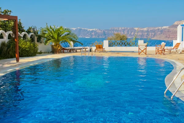 stock image Blue swimming pool in Fira on island of Santorini, Greece.