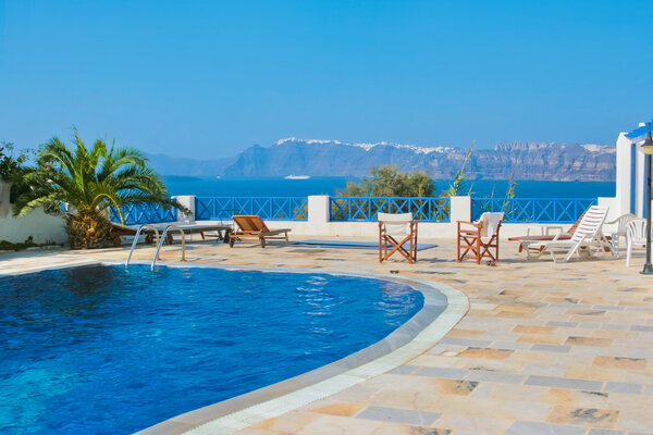 Blue swimming pool in Fira on island of Santorini, Greece.
