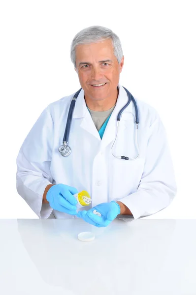Doctor pouring pills into hand — Stock Photo, Image