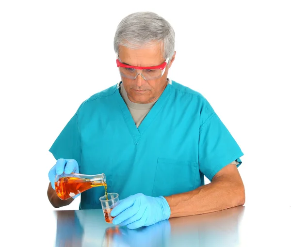 Scientist Pouring Liquids into Beakers — Stock Photo, Image