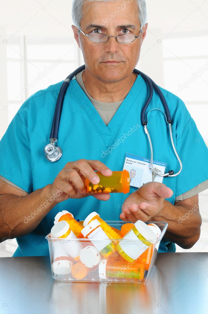 Doctor pouring pills into his hand