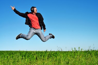 Young Man Enjoying Music clipart