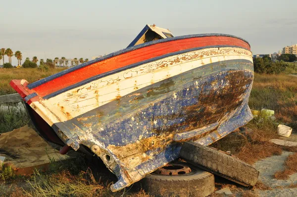 stock image Broken boat abandoned on land