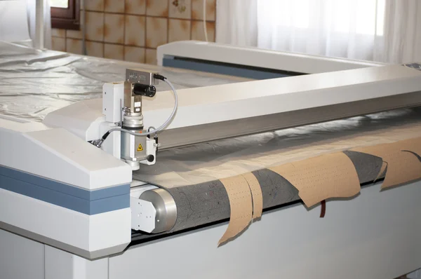 Clothing factory - Automatically cutting textile web — Stock Photo, Image
