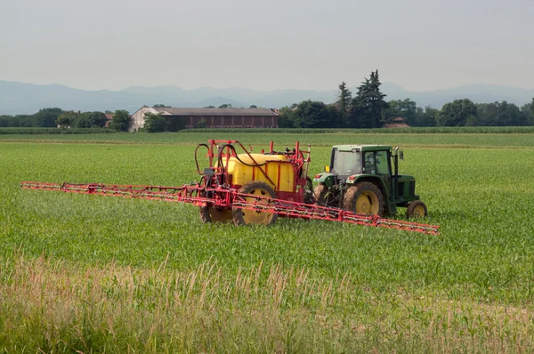 Irrigation with tractor on a wheat field — Stock Photo, Image
