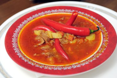 Soup a goulash from vegetables and veal clipart