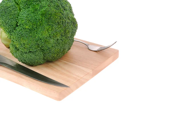 Broccoli on cutting board with knife and fork isolated on white — Stock Photo, Image