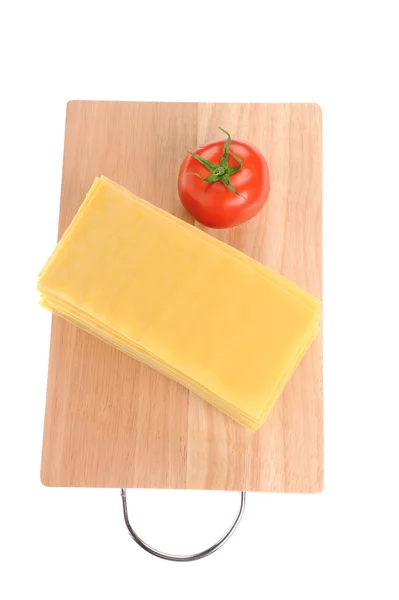 Lasagna pastawith tomato on cutting board isolated on white background — Stock Photo, Image
