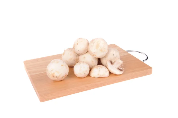 Mushrooms on the cutting board isolated on the white background — Stock Photo, Image